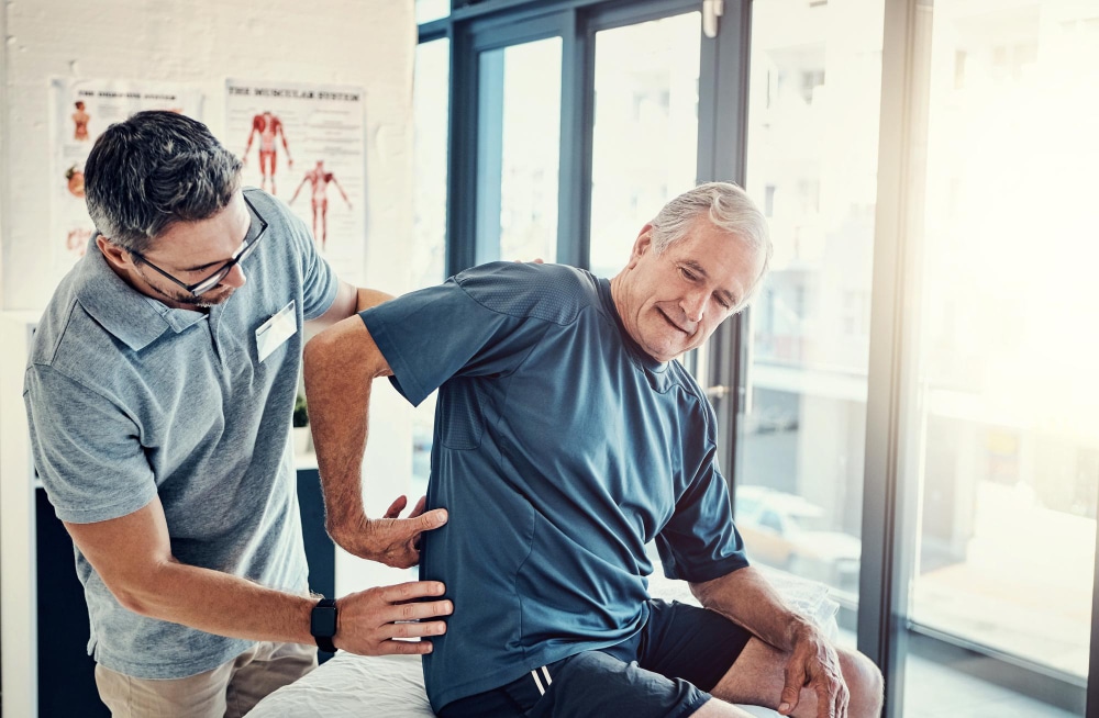 Image of a chiropractor assisting a senior patient